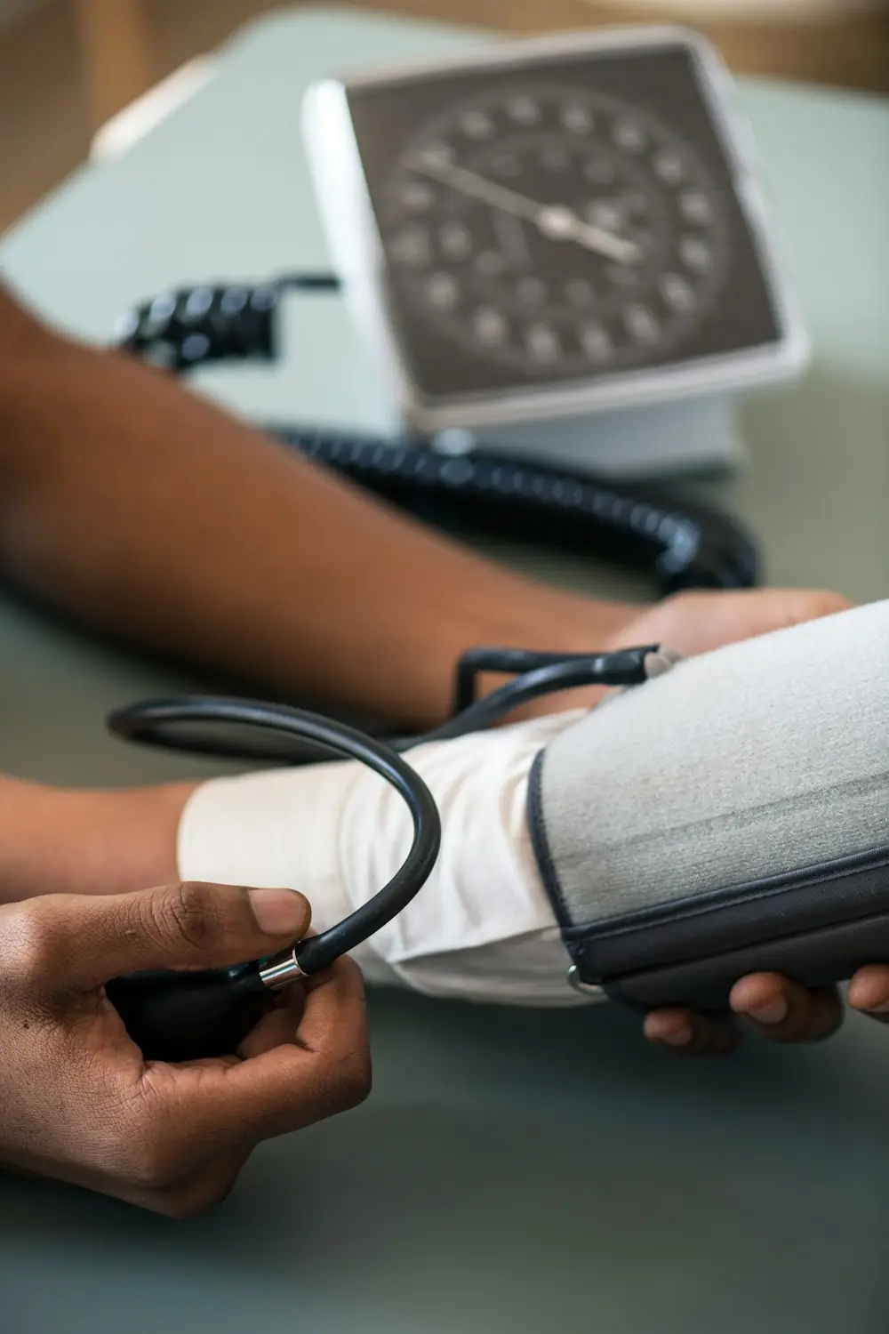person holding blood pressure monitor