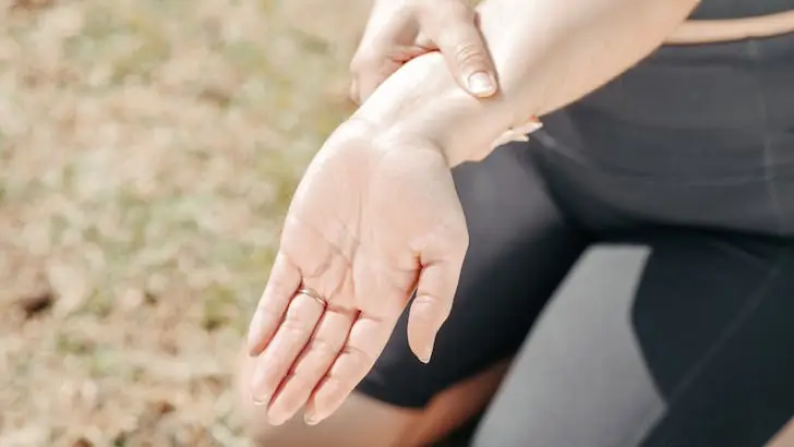 Two conditions that are often misdiagnosed as carpal tunnel syndrome - Woman holding one hand due to pain.
